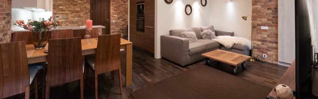 Interior of studio with dining and living zone near kitchen